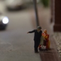 Miniature couple spot something in a window