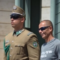 Goofy tourist posing with guard