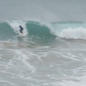 Surfer catches wave