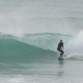 Surfer catches wave