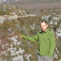 Steve pointing to the very impressive bridge and squinting